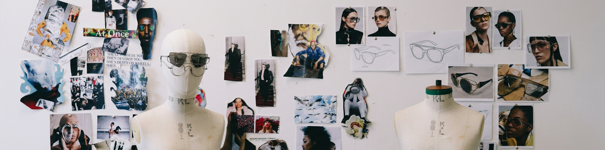 Creative direction studio: dress forms in front of a collage wall of images and references